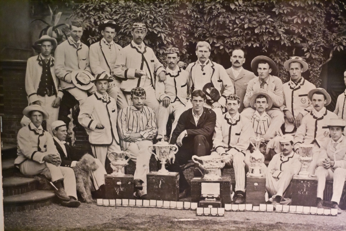 1887 winning crew members posed for a group photo with their trophy.