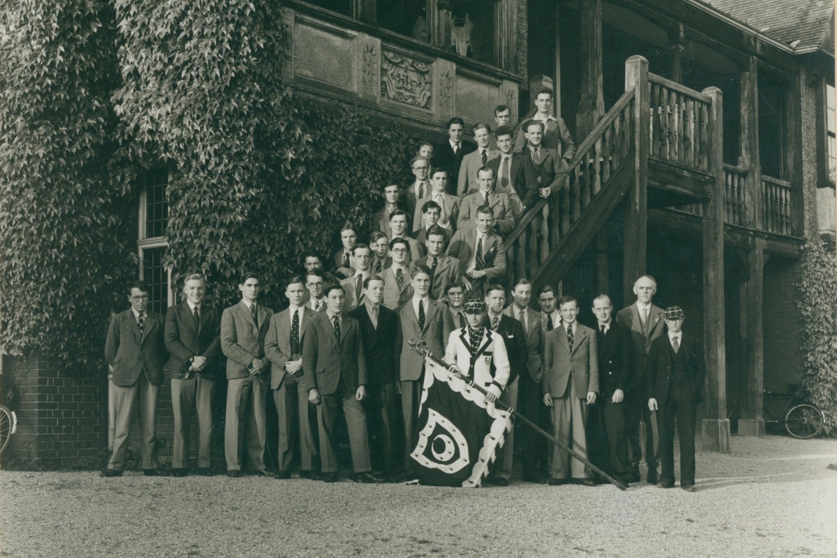 Trinity Hall Boat Club posed with the Trinity all flag at the Boathouse.
